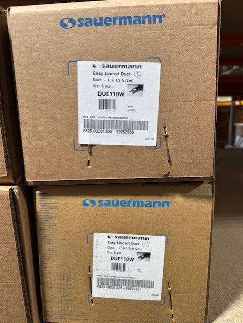 Two cardboard boxes with Sauermann labels on a warehouse floor.