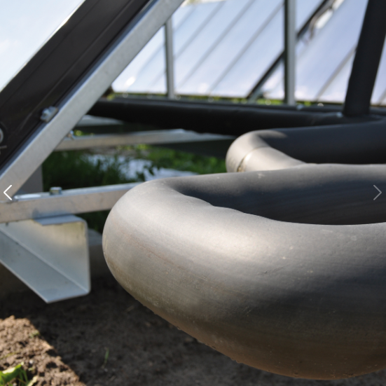 Close-up of a gray metal chair with a blurred outdoor background